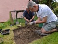 Removing lose soil in Test Pit 2.