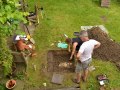 Test Pit 2 carefully removing soil away from discovery.