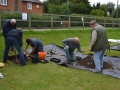 Removing first layer for Test Pit 1 and metal detecting the soil removed.