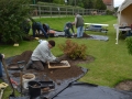 Sieving soil in Test Pit 2.